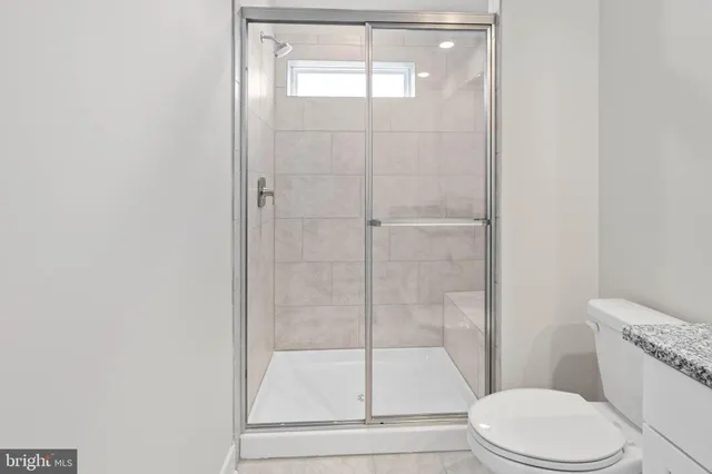 a bathroom with a toilet and a shower