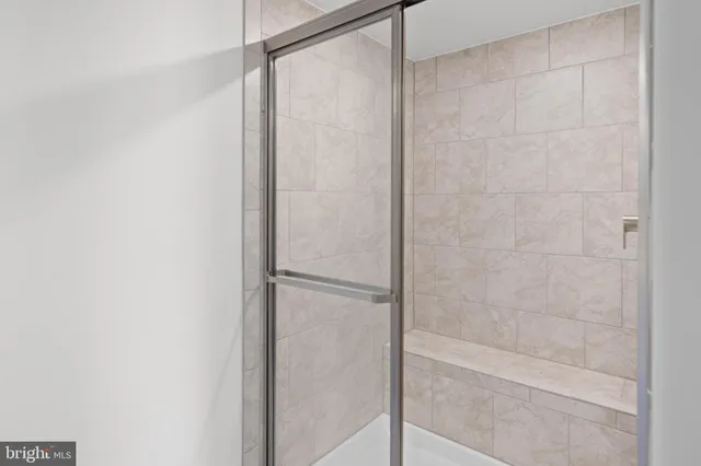 a bathroom with a glass shower door