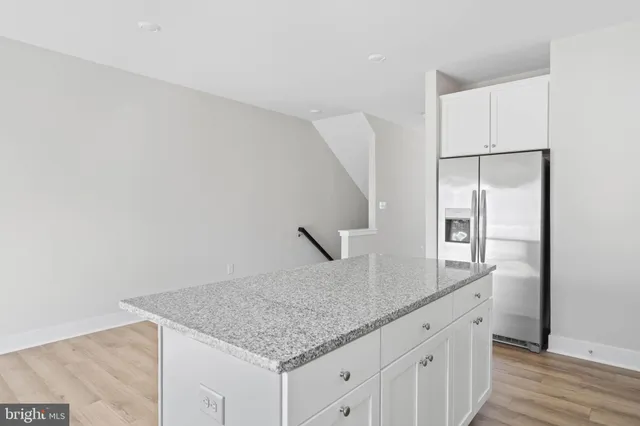 a kitchen with white cabinets a sink and dishwasher