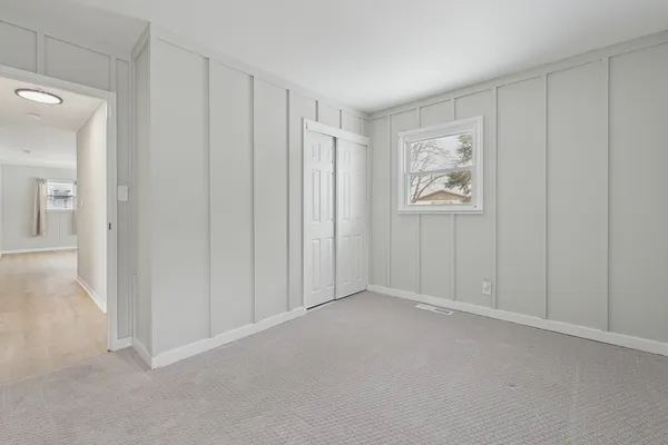 a view of an empty room and closet area