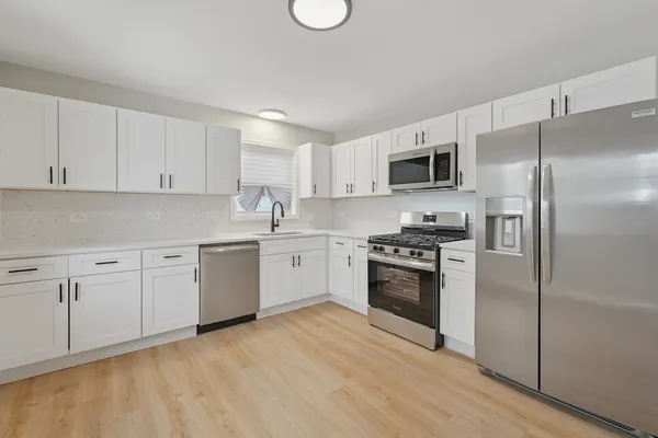 a kitchen with a refrigerator stove and microwave