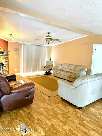 a living room with furniture ceiling fan and a rug