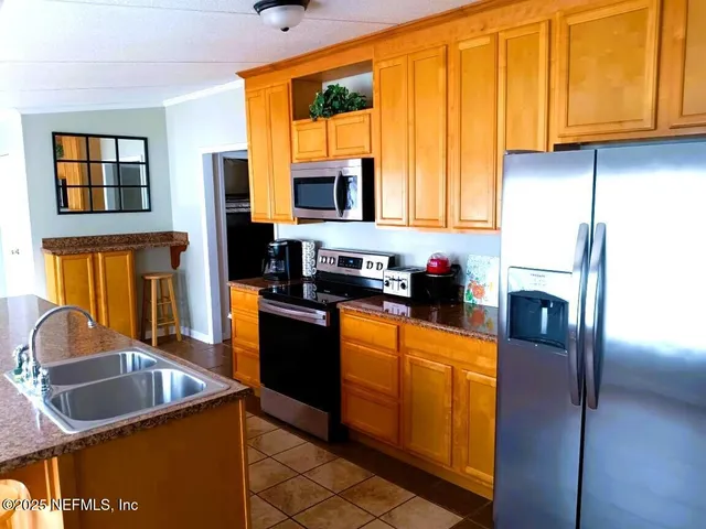 a view of a dining room with furniture and a window