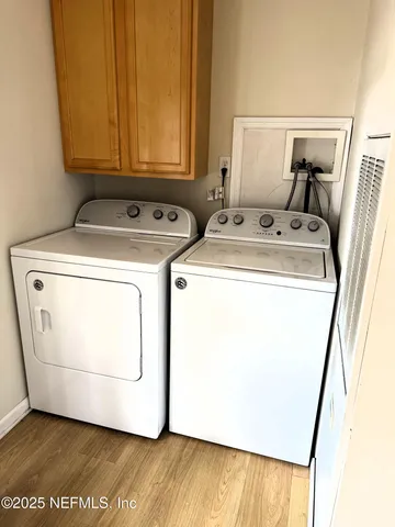 a view of a wooden deck and trees with wooden fence