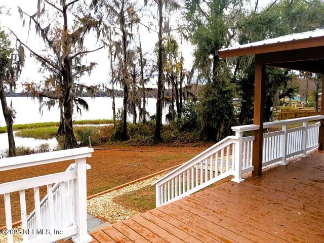 a view of a patio with chairs and floor to ceiling window