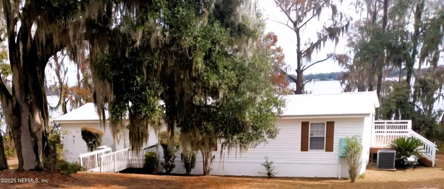 a roof deck with wooden floor and fence