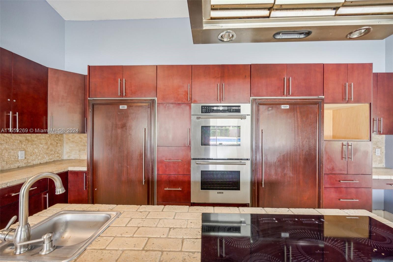 10240 Southwest 124th Street Miami, FL 33176 - Photo 14 of 81 a kitchen with stainless steel appliances kitchen island granite countertop a refrigerator and a stove top oven
