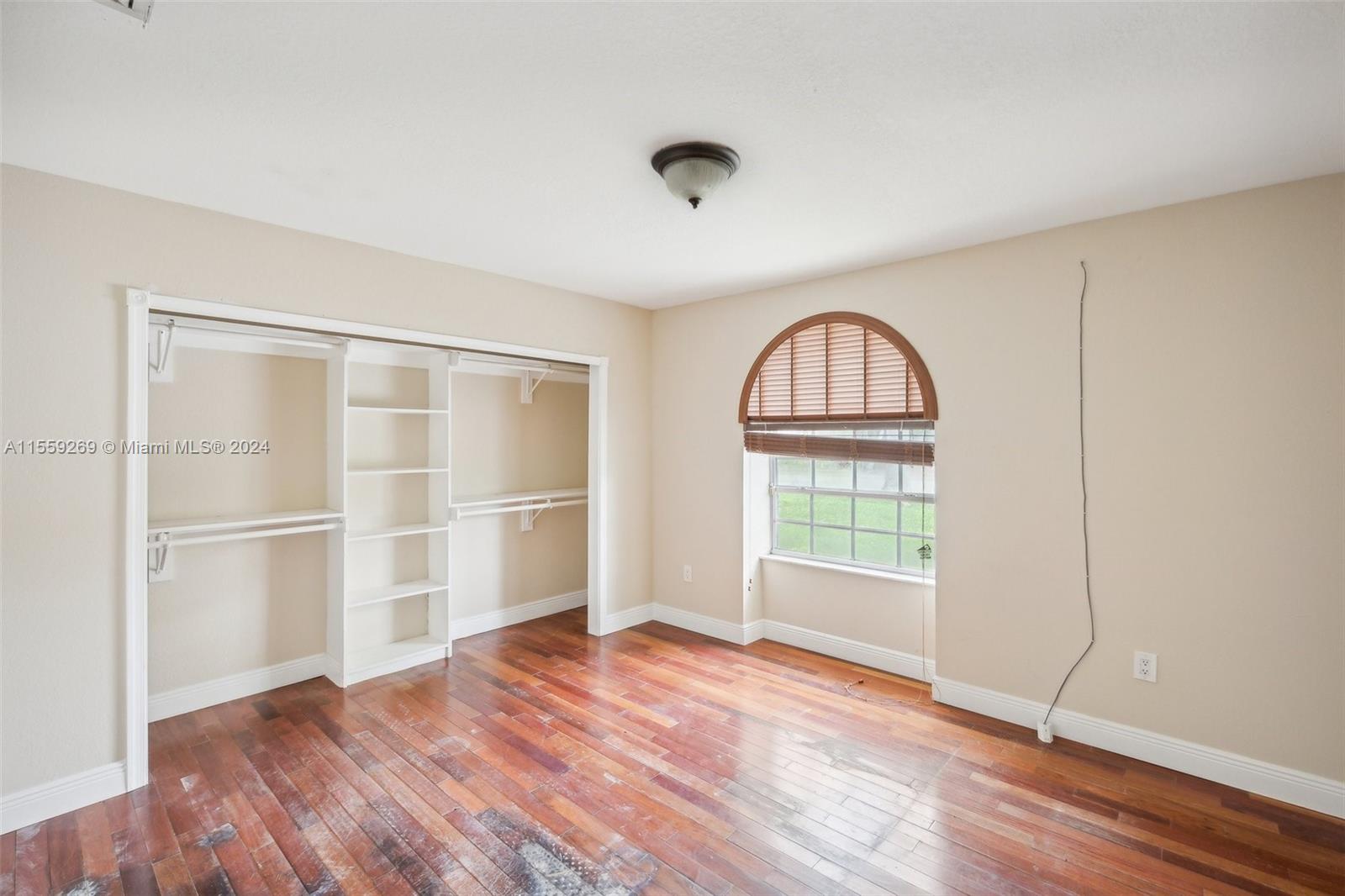 10240 Southwest 124th Street Miami, FL 33176 - Photo 67 of 81 an empty room with wooden floor cabinet and windows