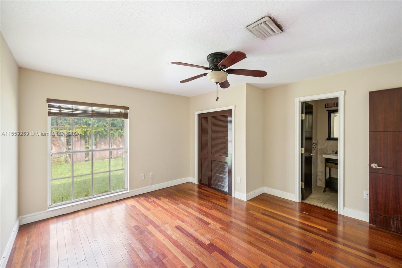 10240 Southwest 124th Street Miami, FL 33176 - Photo 76 of 81 a view of an empty room with wooden floor and a window