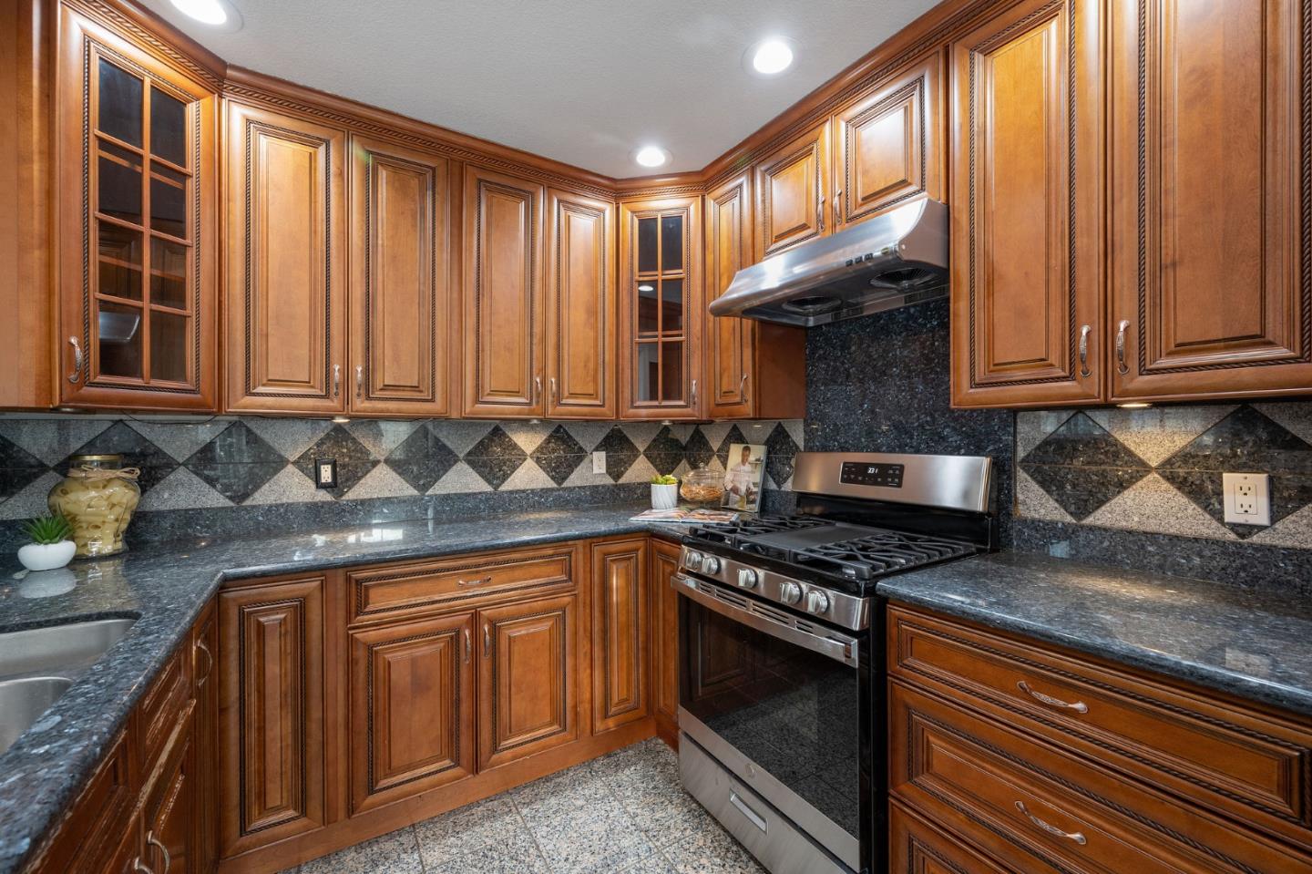 1849 Girard Drive Milpitas, CA 95035 - Photo 15 of 33 a kitchen with stainless steel appliances granite countertop wooden cabinets a stove top oven