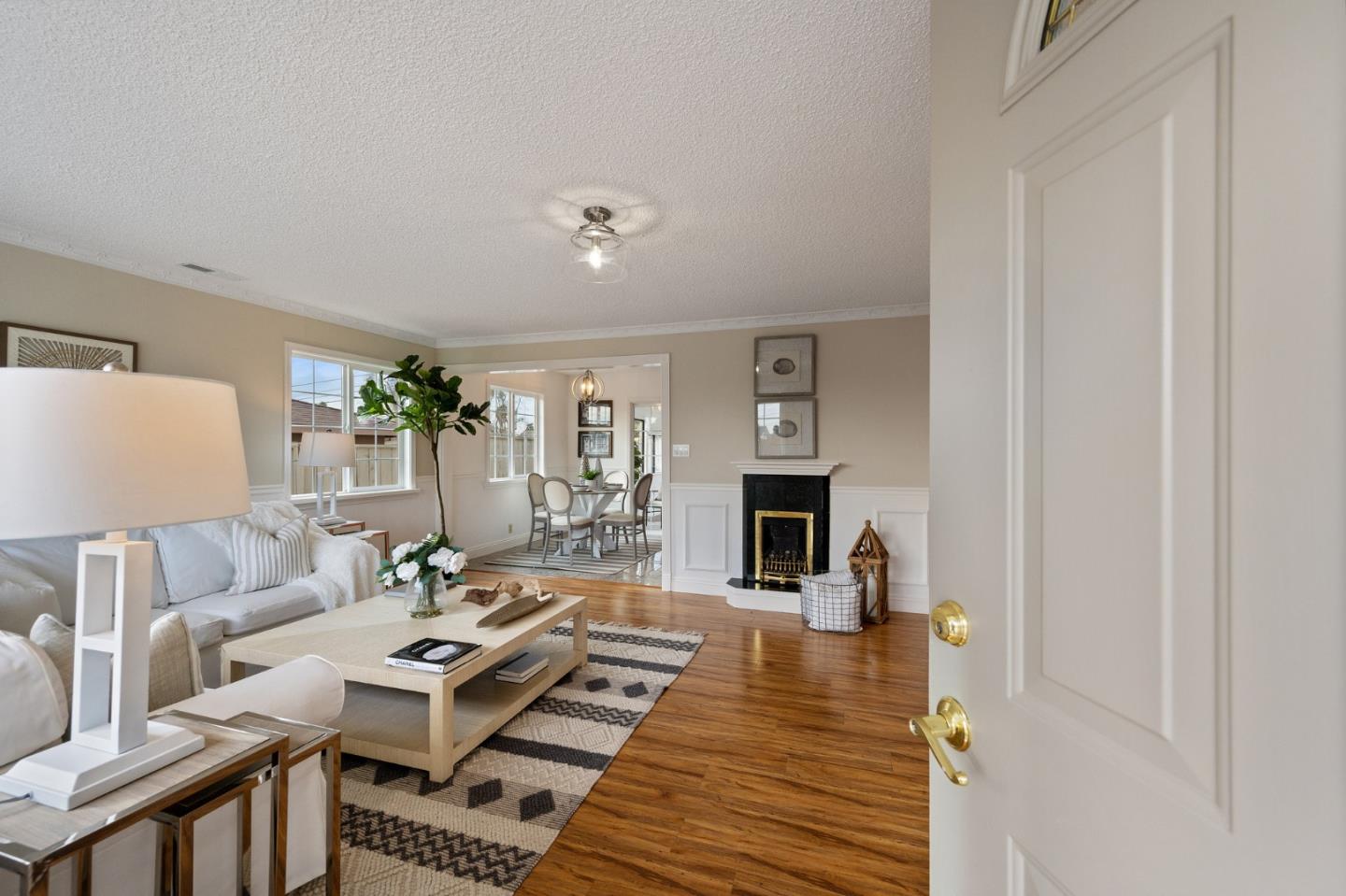 1849 Girard Drive Milpitas, CA 95035 - Photo 5 of 33 a living room with furniture a fireplace and a table with wooden floor