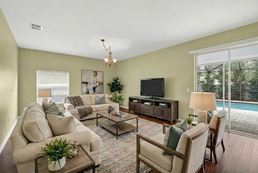 11543 Addison Chase Drive Riverview, FL 33579 - Photo 13 of 45 a living room with furniture a flat screen tv and a large window