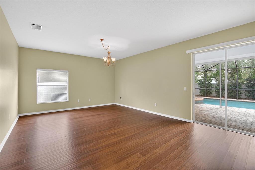 11543 Addison Chase Drive Riverview, FL 33579 - Photo 14 of 45 wooden floor in an empty room with a window
