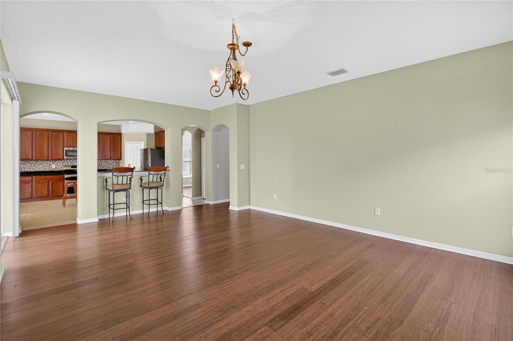 11543 Addison Chase Drive Riverview, FL 33579 - Photo 15 of 45 a view of a livingroom with a furniture wooden floor and a kitchen
