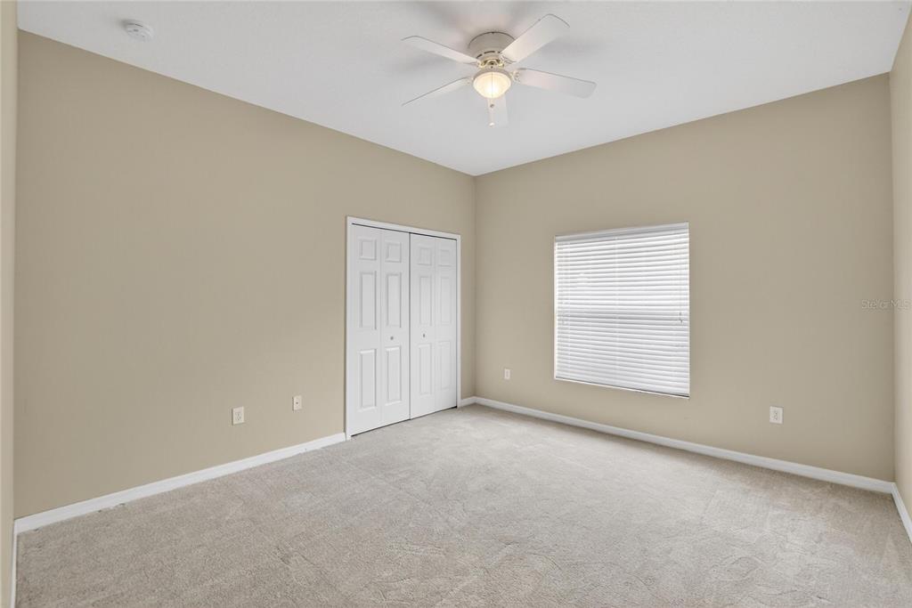 11543 Addison Chase Drive Riverview, FL 33579 - Photo 17 of 45 an empty room with a window and a fan