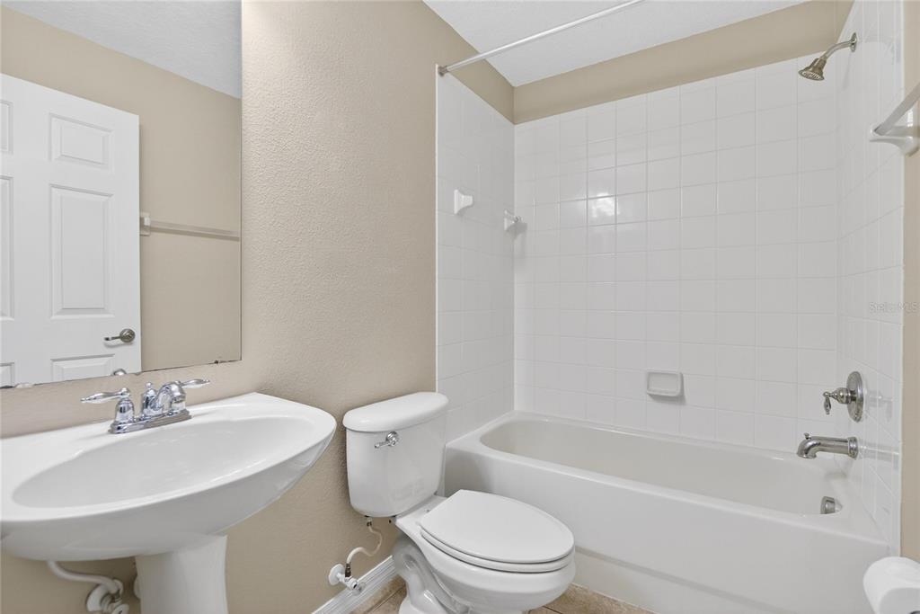 11543 Addison Chase Drive Riverview, FL 33579 - Photo 18 of 45 a bathroom with a bathtub shower sink mirror vanity and toilet