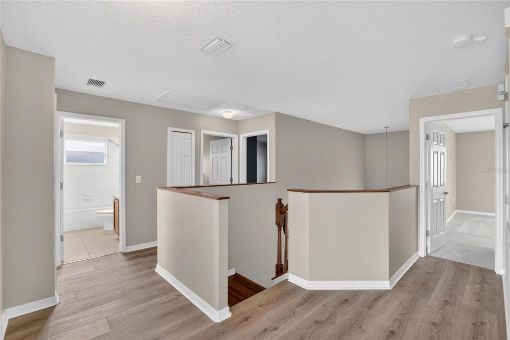 11543 Addison Chase Drive Riverview, FL 33579 - Photo 21 of 45 a view of a kitchen with a refrigerator and wooden floor