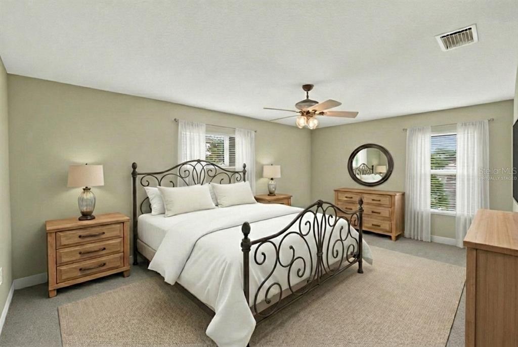 11543 Addison Chase Drive Riverview, FL 33579 - Photo 22 of 45 a bedroom with bed and a chandelier
