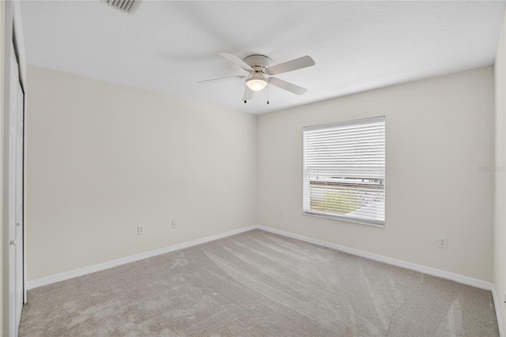 11543 Addison Chase Drive Riverview, FL 33579 - Photo 33 of 45 an empty room with a window and a fan
