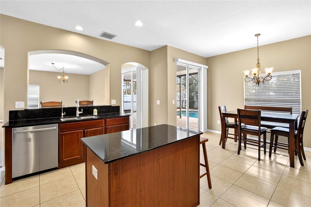 11543 Addison Chase Drive Riverview, FL 33579 - Photo 6 of 45 a large kitchen with kitchen island a sink table and chairs