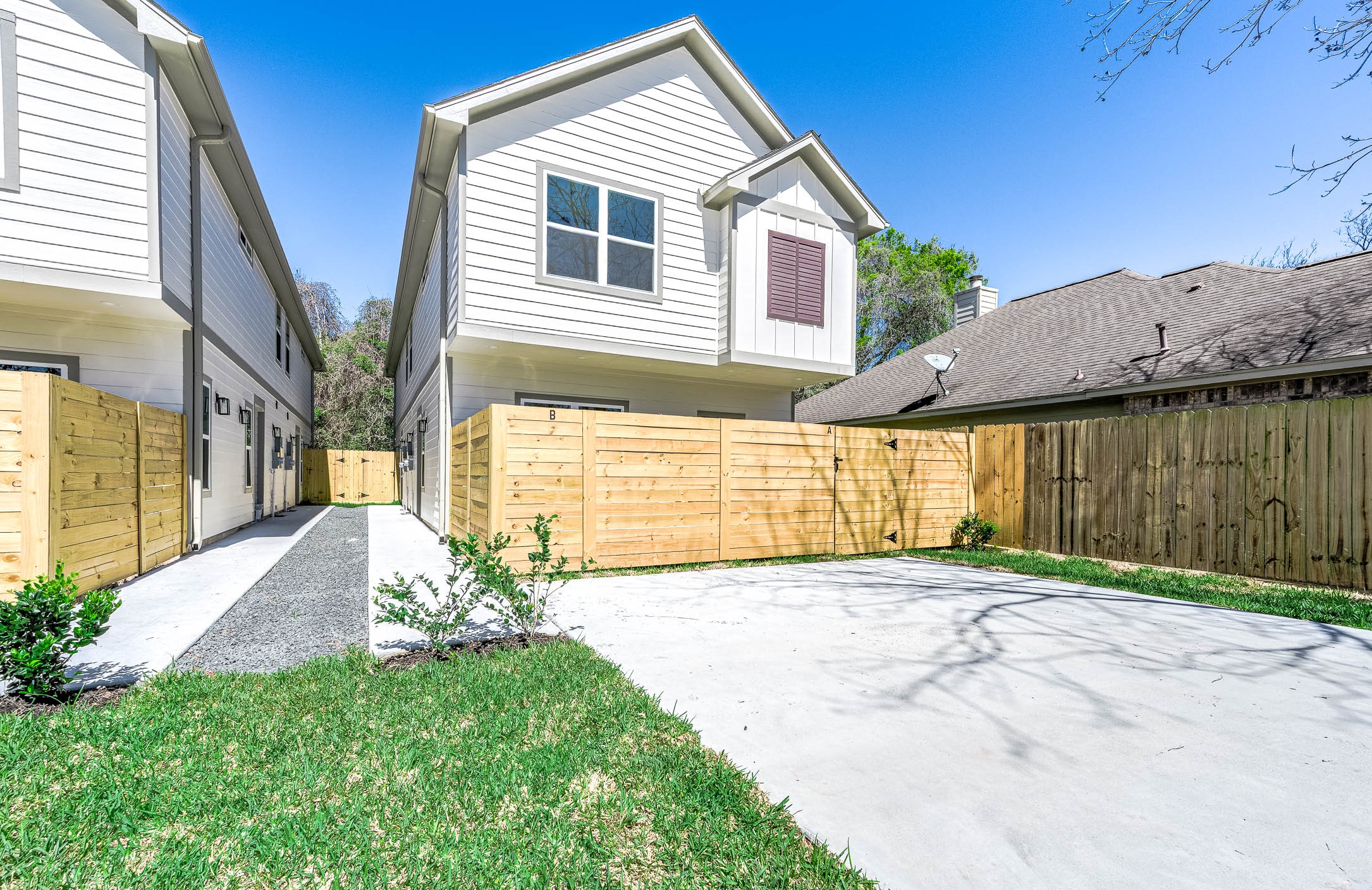 2018 Hampton Street, Unit B Houston, TX 77088 - Photo 1 of 30 Modern two-story duplex with a stylish gabled roof and functional layout. This unit includes a private fenced yard, ideal for relaxing, entertaining, or pets. Located in a growing area with easy access to the Heights, Oak Forest, and Downtown Houston, offering a convenient lifestyle close to dining, shopping, and entertainment.