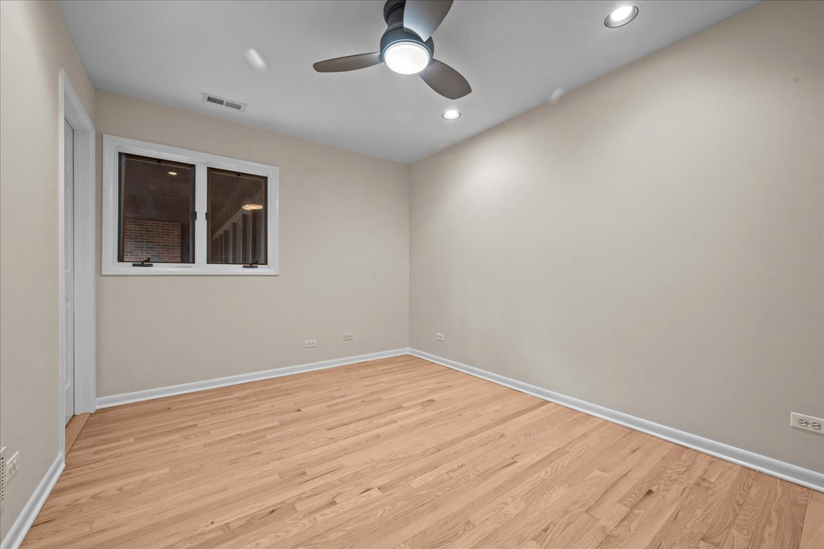 62 East Center Avenue, Unit 62 Lake Bluff, IL 60044 - Photo 14 of 19 wooden floor in an empty room with a window