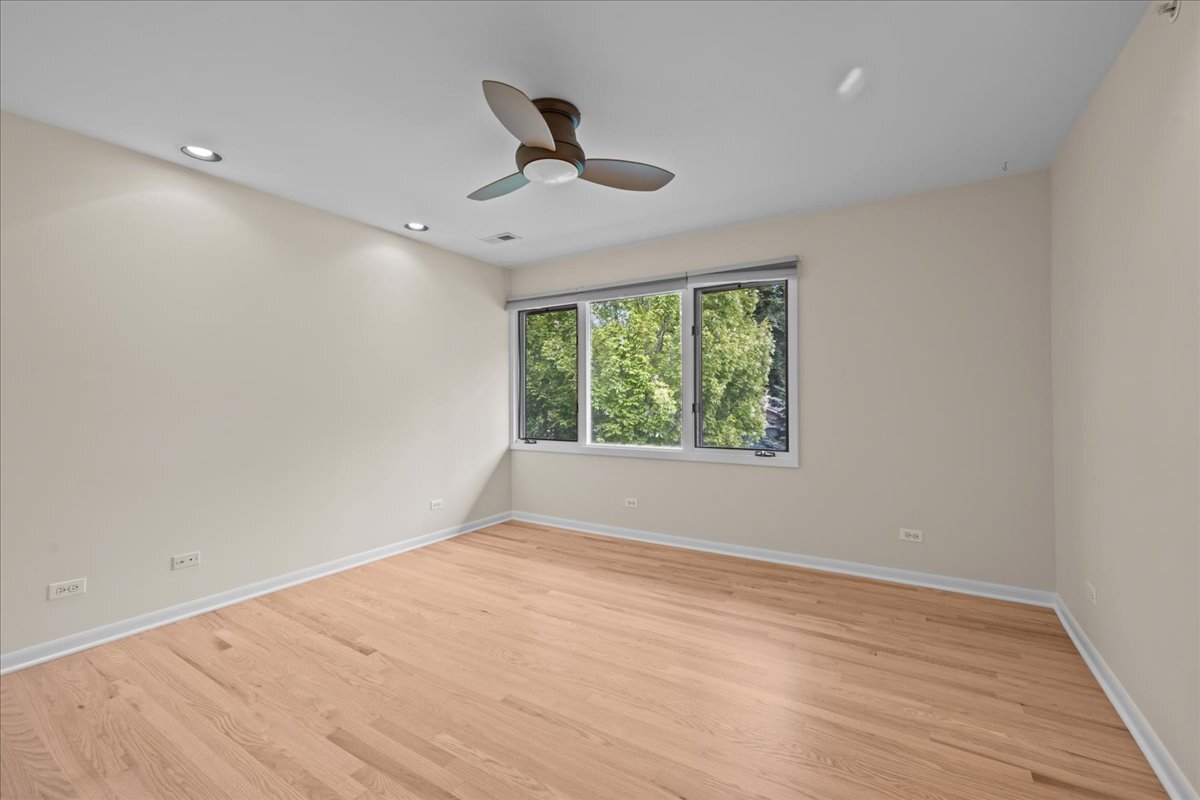 62 East Center Avenue, Unit 62 Lake Bluff, IL 60044 - Photo 17 of 19 wooden floor in an empty room with a window