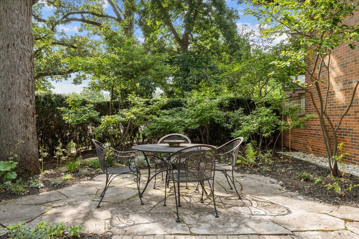 62 East Center Avenue, Unit 62 Lake Bluff, IL 60044 - Photo 2 of 19 a patio with table and chairs and potted plants