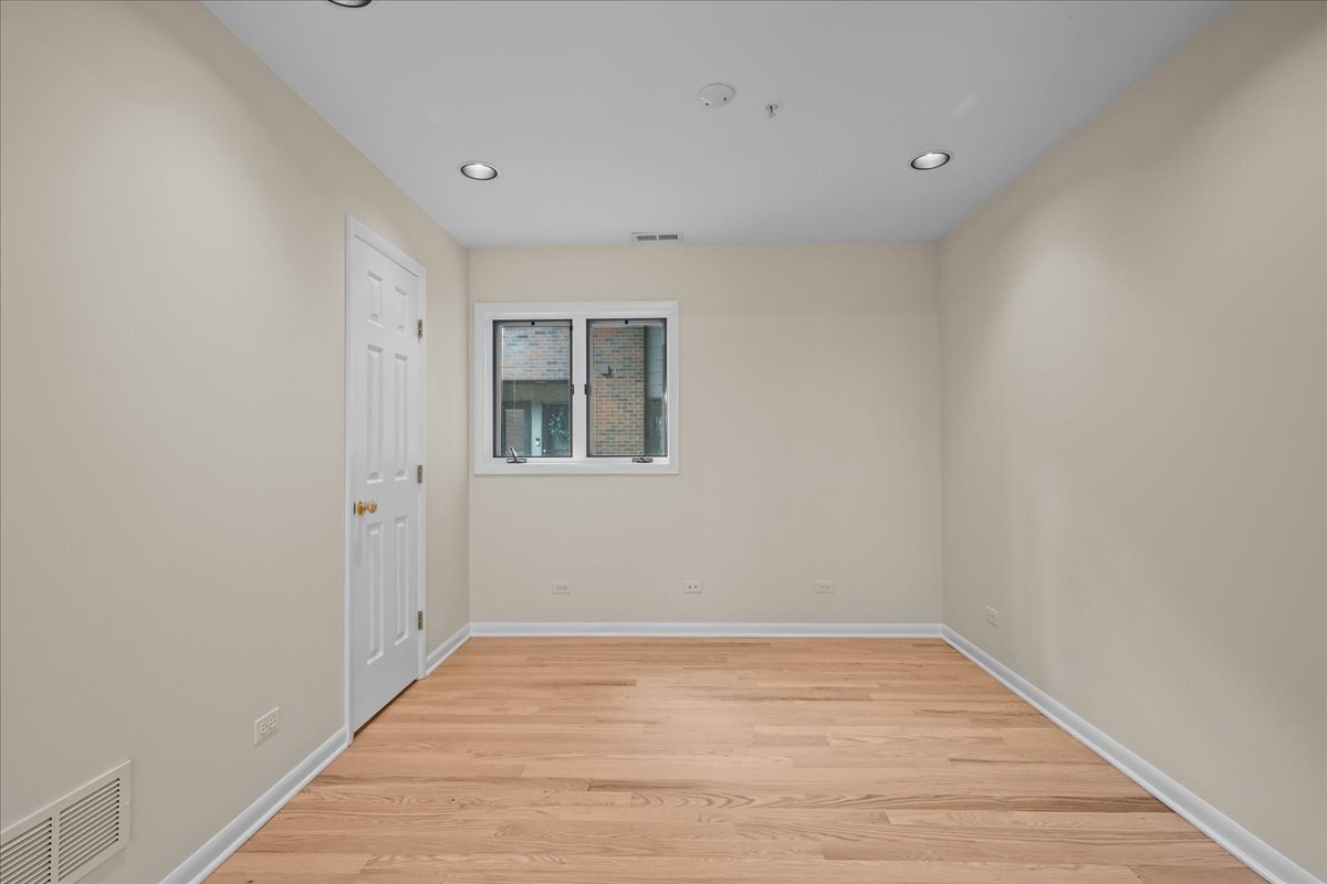 62 East Center Avenue, Unit 62 Lake Bluff, IL 60044 - Photo 5 of 19 a view of empty room with wooden floor and fan