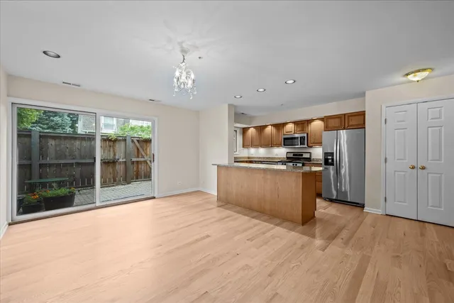 a view of kitchen with stainless steel appliances granite countertop a refrigerator and a sink
