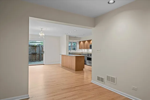 a view of kitchen and hall with wooden floor