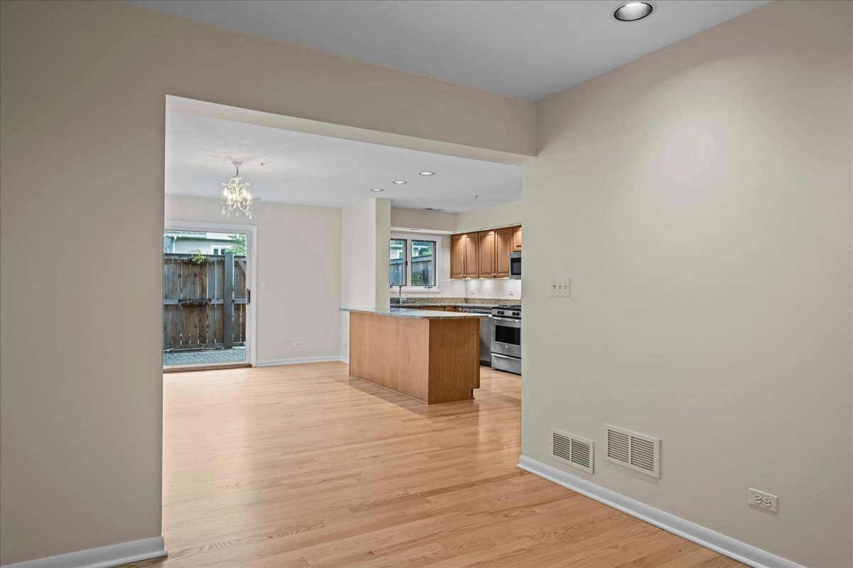 62 East Center Avenue, Unit 62 Lake Bluff, IL 60044 - Photo 9 of 19 a view of kitchen and hall with wooden floor