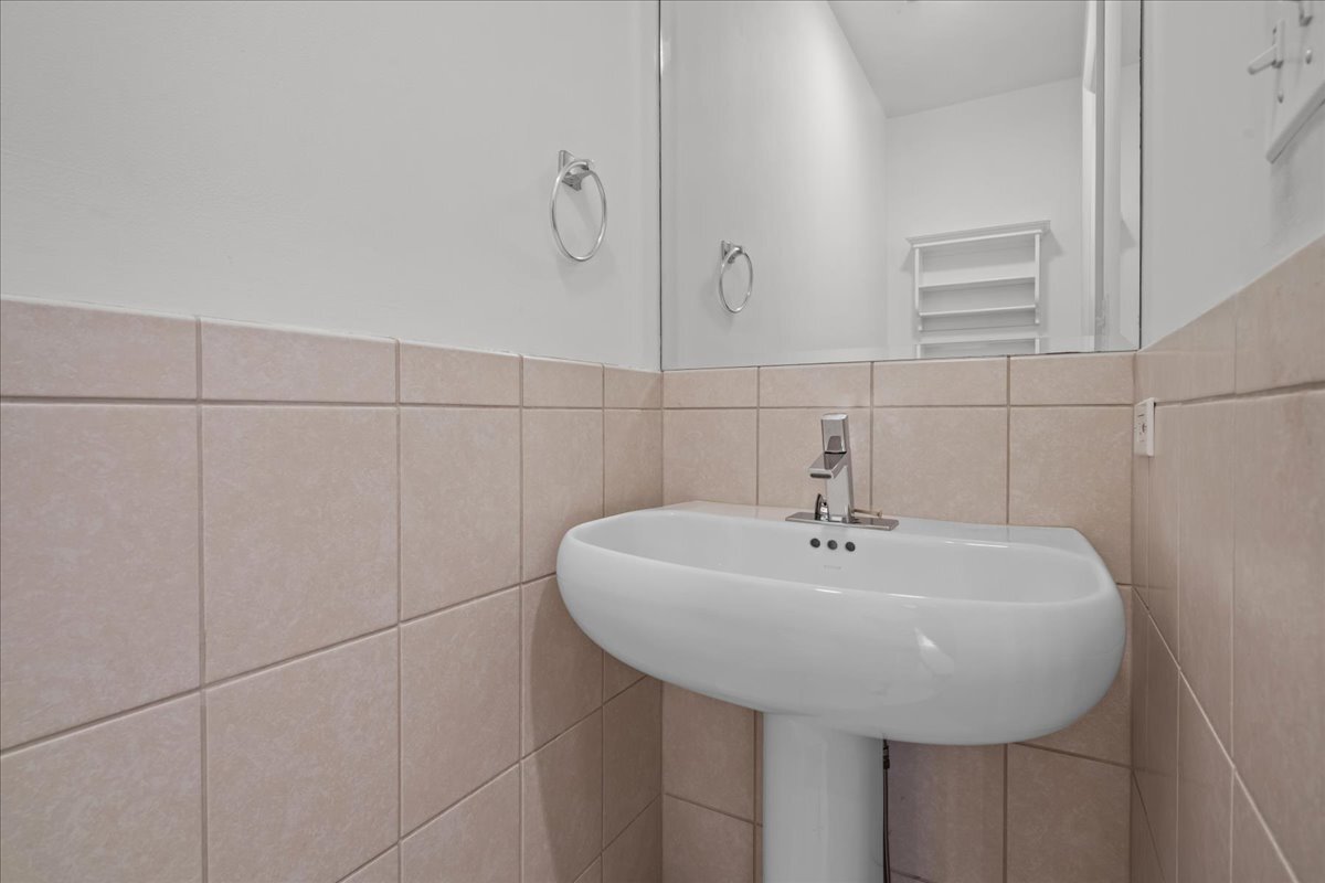 62 East Center Avenue, Unit 62 Lake Bluff, IL 60044 - Photo 10 of 19 a bathroom with a sink and mirror