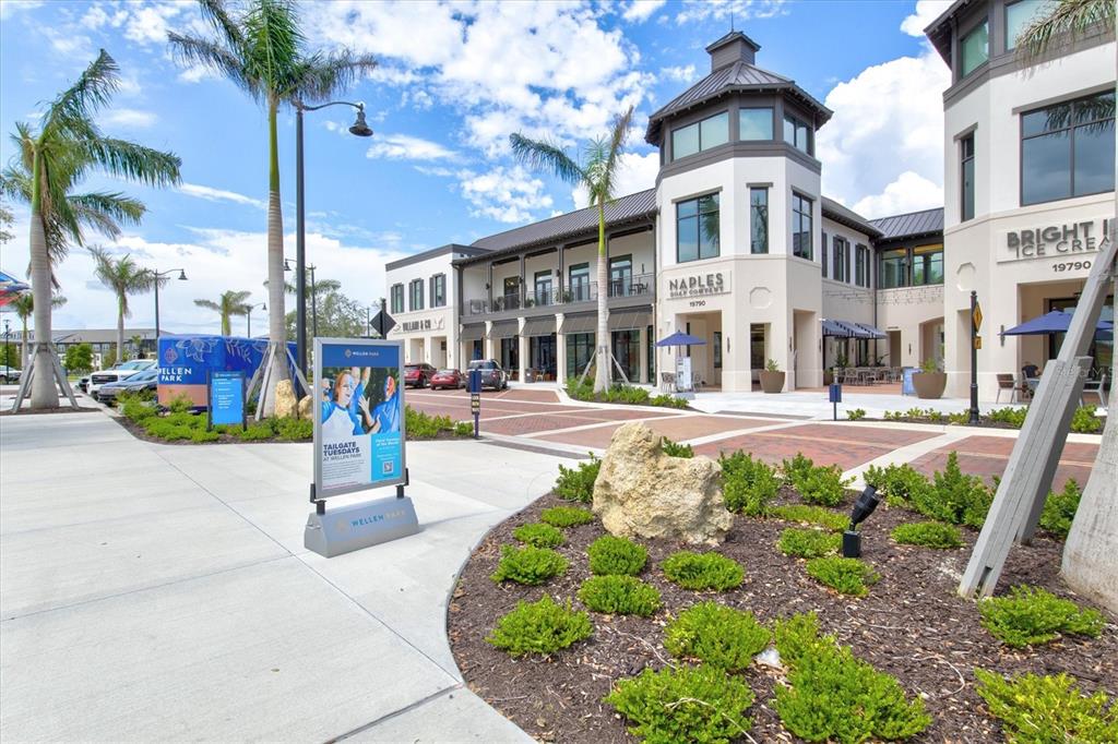 14113 Hydrangea Avenue Port Charlotte, FL 33953 - Photo 12 of 20 a front view of multi story residential apartment building with yard and outdoor seating