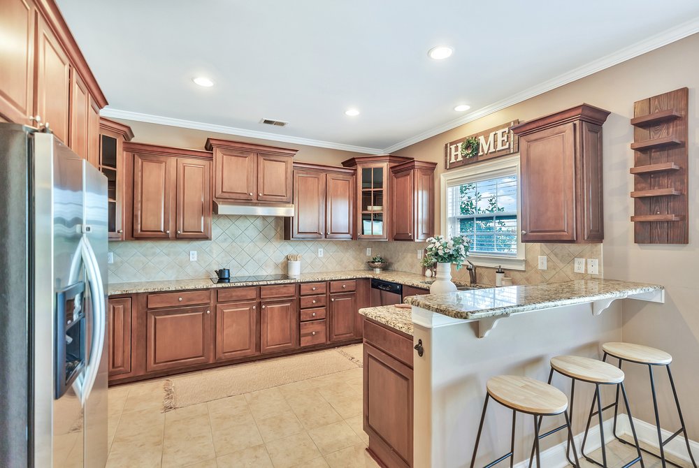 15 Fawn Hill Drive Anderson, SC 29621 - Photo 12 of 38 This inviting kitchen boasts warm cabinetry, practical countertops, and ample space for everyday living.