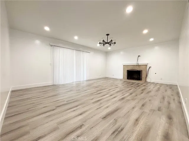 a view of empty room with a fireplace