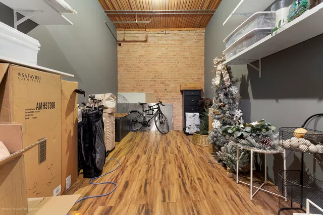 a view of a balcony with chairs and wooden floor