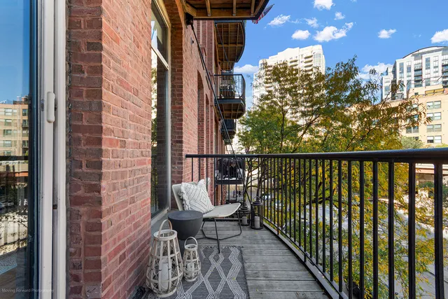 a balcony with chairs and wooden floor
