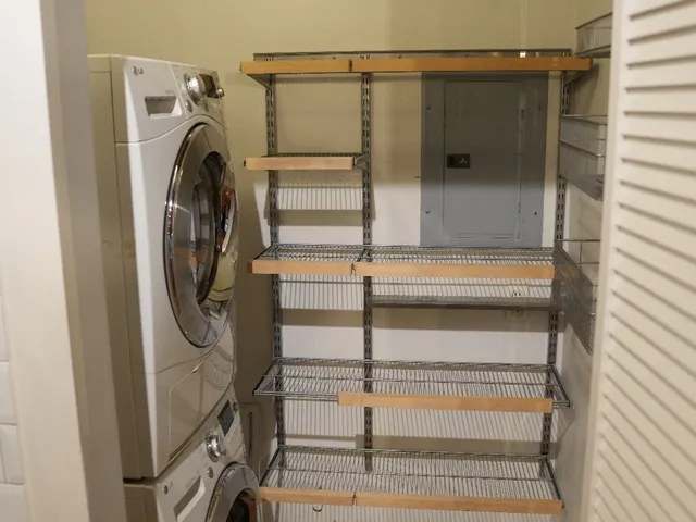a view of walk in closet with empty racks