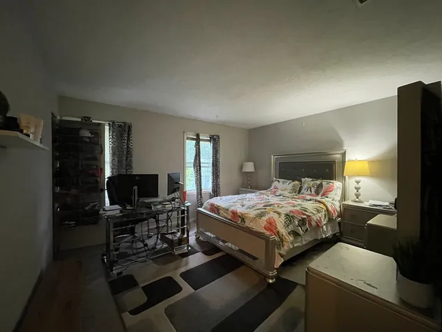a bedroom with a bed and a television