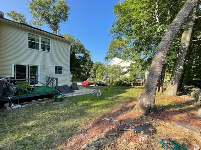 a view of a house with backyard and sitting area