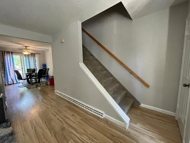 a view of entryway and hall with wooden floor