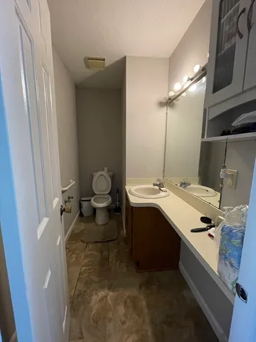 a room with two washing machine and sink