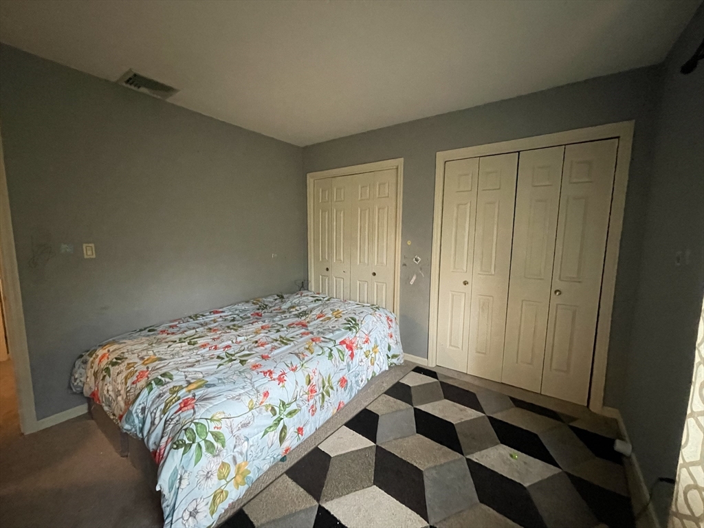 57 First Street Worcester, MA 01602 - Photo 10 of 26 a bedroom with a bed and a cabinet