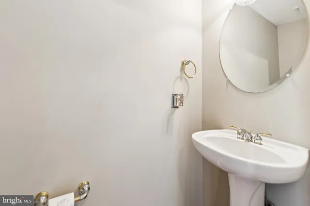 a bathroom with a sink a mirror and a toilet