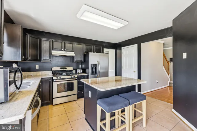 a kitchen with a stove a sink and a refrigerator