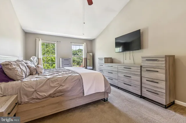 a bedroom with a bed and flat screen tv