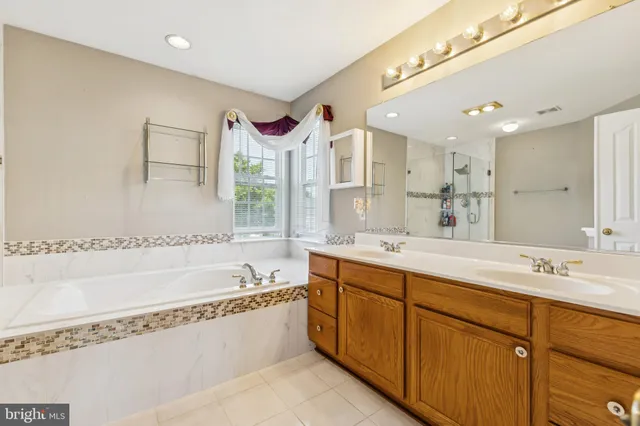 a spacious bathroom with a sink mirror and a bathtub
