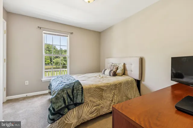 a bedroom with two beds and a flat screen tv