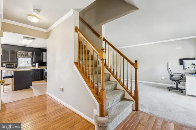 a view of a livingroom with wooden floor and stairs